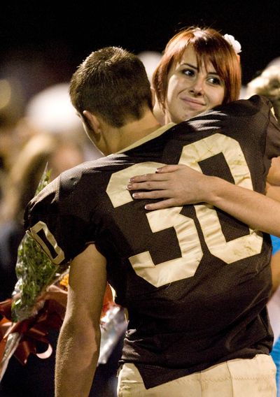 Sophomore homecoming representatives Whitney Kropp and Josh Awrey give each other a hug during the homecoming ceremony on the Ogemaw Heights High School football field Friday night, Sept. 28, 2012, in West Branch, Mich. Kropp was named to the homecoming court of the 800-student school earlier this month, but said she felt betrayed after some students suggested her selection was a joke. (John Galloway / Detroit News)
