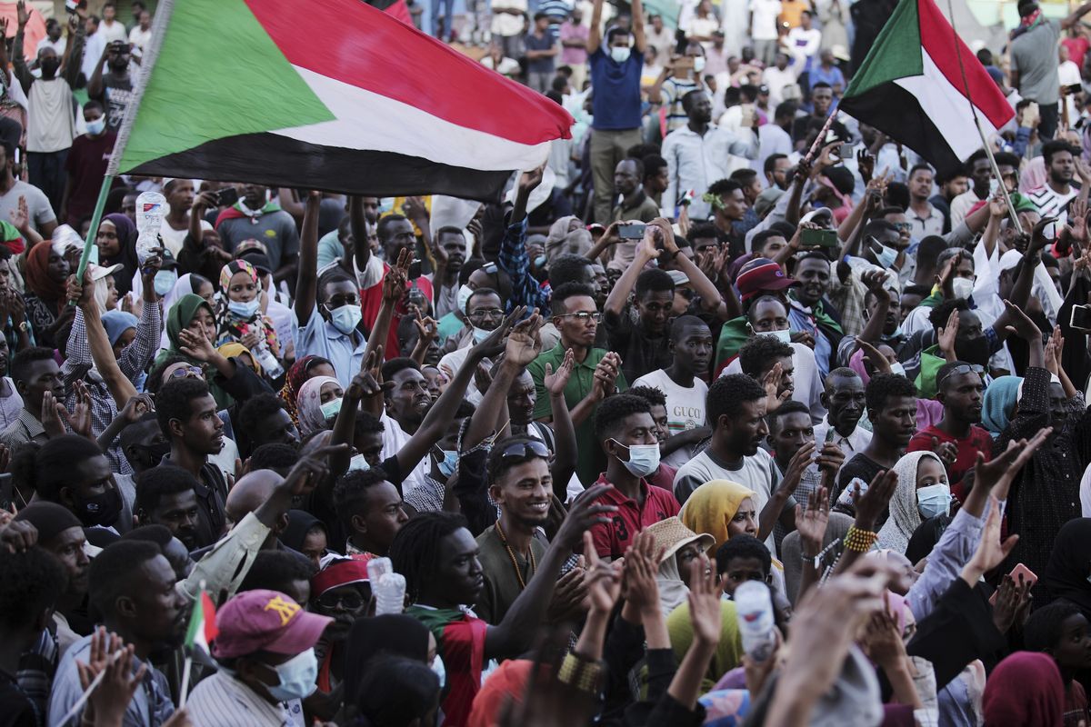 People chant slogans during a protest in Khartoum, Sudan, Saturday, Oct. 30, 2021. Pro-democracy groups called for mass protest marches across the country Saturday to press demands for re-instating a deposed transitional government and releasing senior political figures from detention.  (Marwan Ali)