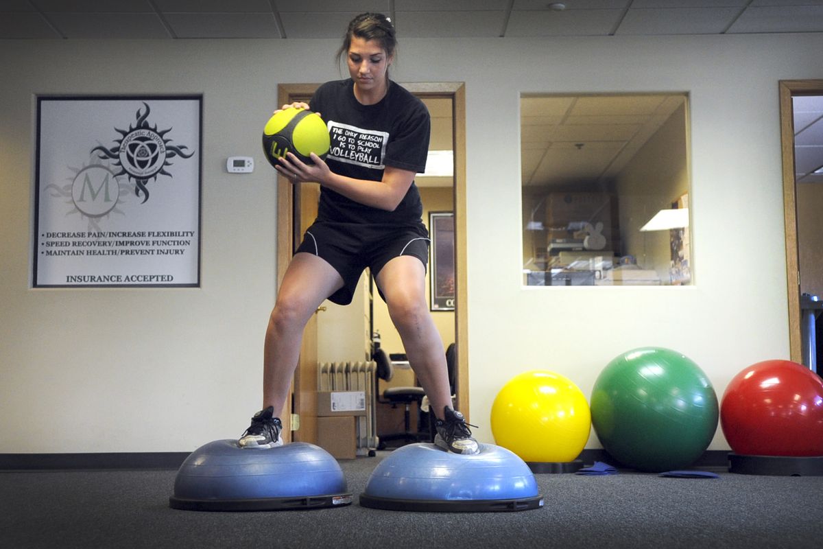 East Valley’s Allie Riggin, recovering from a torn ACL, works on her balance at U-District Physical Therapy. (Christopher Anderson / The Spokesman-Review)