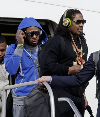 It’s a touch-down for Seahawks Richard Sherman, left, and Marshawn Lynch. (Associated Press)