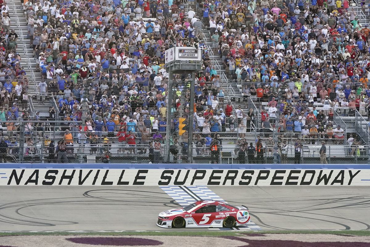Kyle Larson crosses the finish line to win a NASCAR Cup Series auto race at Nashville Superspeedway Sunday in Lebanon, Tenn. Larson led 264 of 300 laps for his third consecutive win.  (Mark Humphrey)