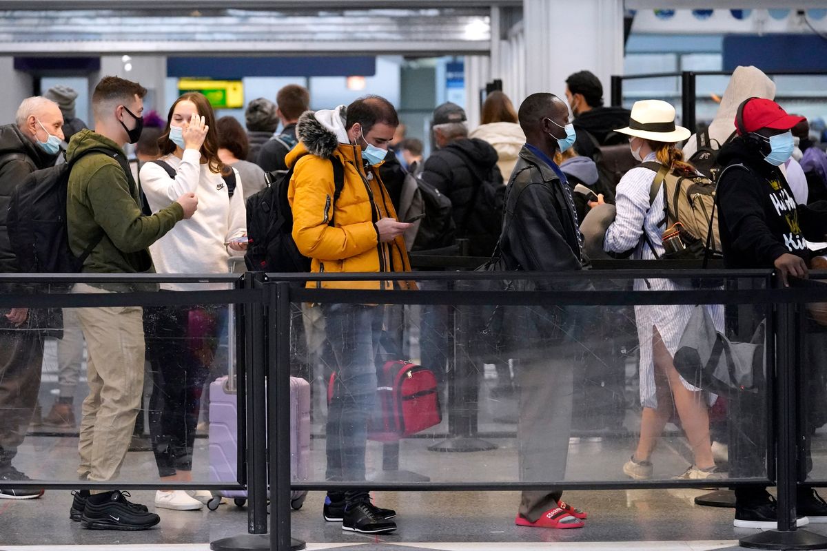 Travelers line up for flights at O