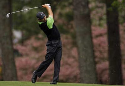 
Third-round leader Trevor Immelman hits from the 2nd fairway. Associated Press
 (Associated Press / The Spokesman-Review)