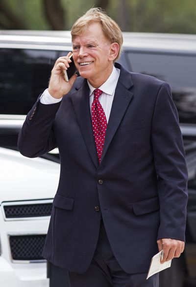 Former Ku Klux Klan leader David Duke talks on a cellphone as he arrives at the Louisiana Secretary of State's office in Baton Rouge, La., on March 22  to register to run for the U.S. Senate. (Max Becherer / Associated Press)