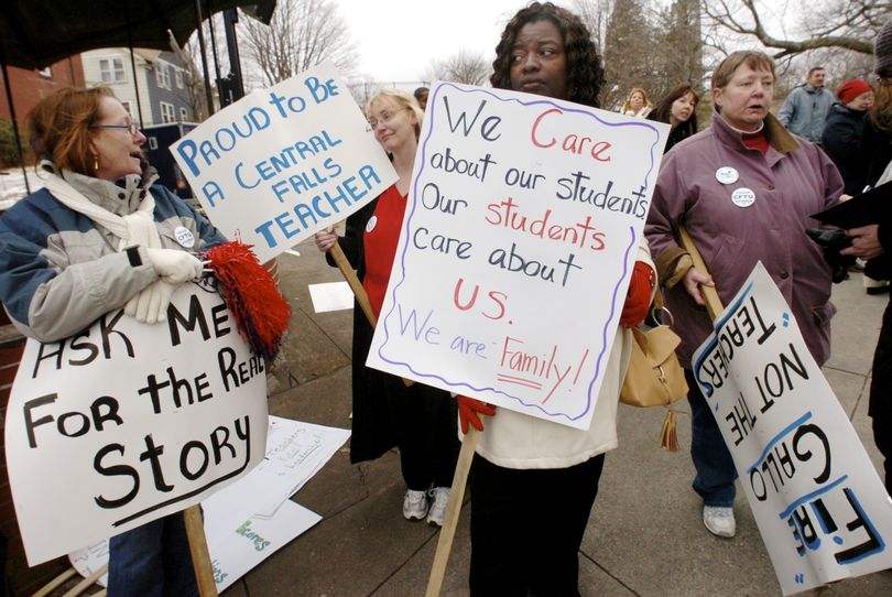 In this Tuesday, Feb, 23, 2010 photo, Central Falls High School math teacher and athletic director Kathy Luther, left, librarian Debbie Fisher, second from left, English teacher Deloris Davis Grant, second from right, and math teacher Pat McKenna, right, protest outside the school before a school committee meeting in Central Falls, R.I. The committee voted during the evening meeting to fire every teacher at the high school  at the end of the school year. (Butch Adams / The Pawtucket Times)