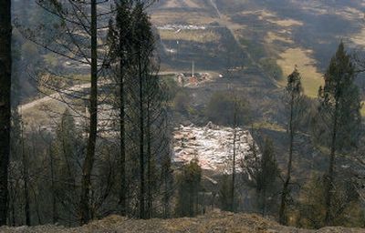 
The burned remains of Boulder Creek Outfitters smolder in the wake of the Poe Cabin fire on Saturday, south of White Bird, Idaho. Associated Press
 (Associated Press / The Spokesman-Review)