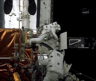 ORG XMIT: DN206 In this image from NASA TV astronauts Drew Feustel, top, and John Grunsfeld  work to upgrade the Hubble Space Telescope during a spacewalk, Thursday, May 14, 2009. (AP Photo/NASA TV) (The Spokesman-Review)