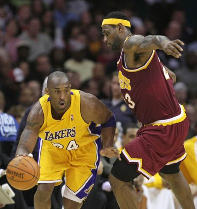 Los Angeles Lakers’ Kobe Bryant tries to get past Cleveland’s LeBron James during the second quarter Thursday. (Associated Press / Associated Press)