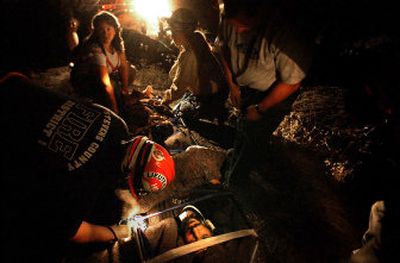 
Frank Ulijohn, 35, is prepared for transport after he fell from a cliff west of Tum Tum on Wednesday evening. Ulijohn suffered broken bones and contusions. 
 (Jed Conklin / The Spokesman-Review)