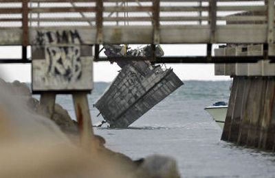 
The wing of a seaplane that crashed off Miami Beach, Fla., is lifted by a crane from the water Tuesday. The rest of the plane won't be raised until today. 
 (Associated Press / The Spokesman-Review)