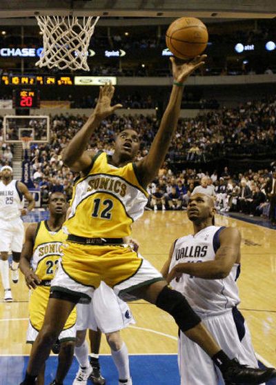 
Seattle's Damien Wilkins attempts a shot as Dallas' Jerry Stackhouse, right, looks on.
 (Associated Press / The Spokesman-Review)