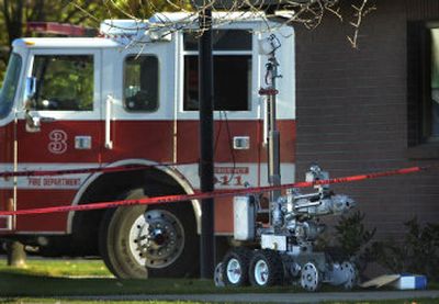 
A police robot approaches a container of pipe bombs outside Spokane Fire Station No. 3 on Friday. A man found the bombs in his storage unit and brought them in.
 (Holly Pickett / The Spokesman-Review)