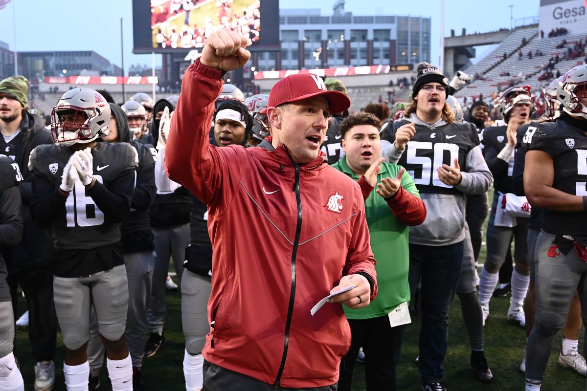 Washington State coach Jake Dickert sings the school fight song after a win over Arizona State at Gesa Field on Nov. 12 in Pullman.  (James Snook/For the Spokesman-Review)