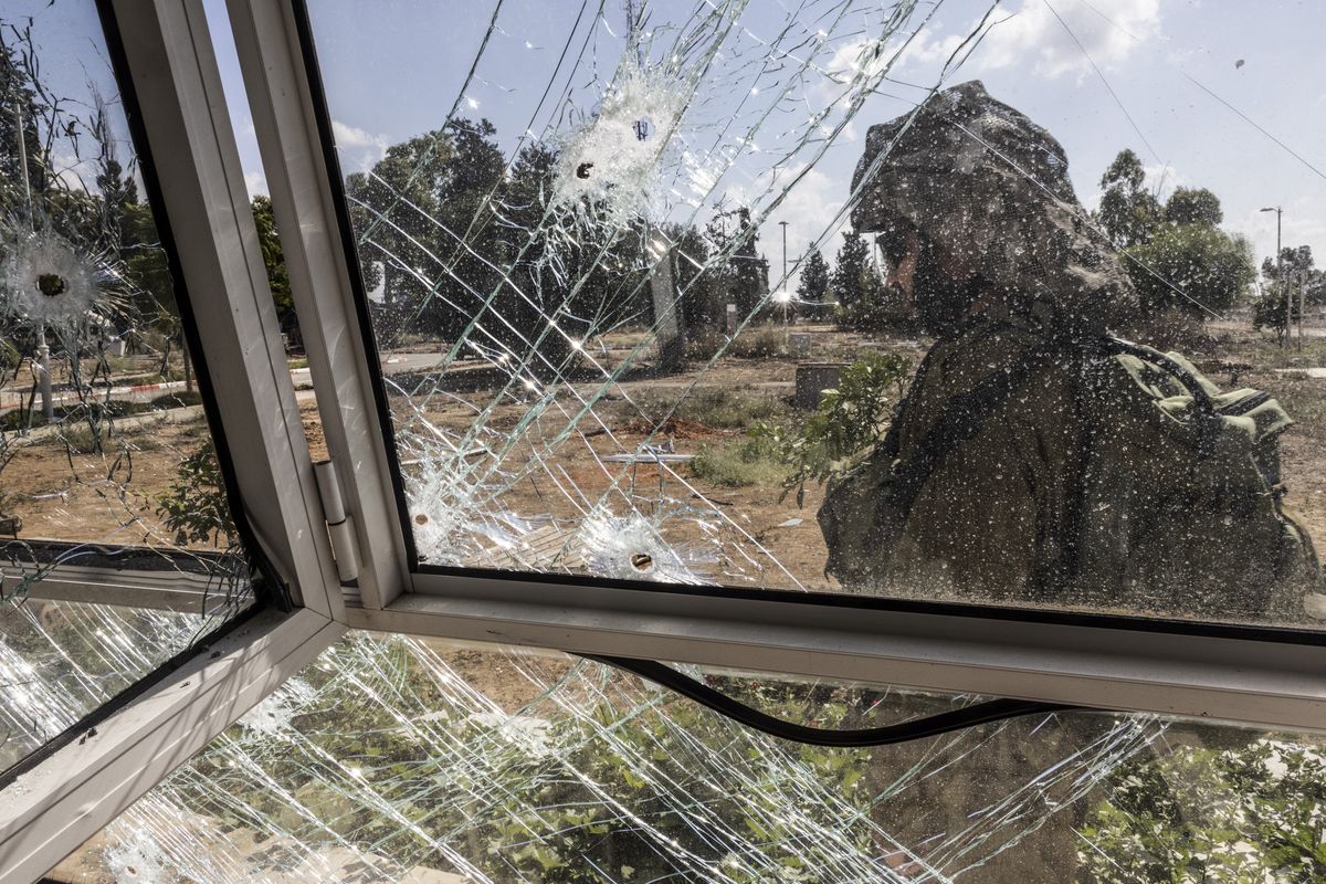 An Israeli soldier passes a family