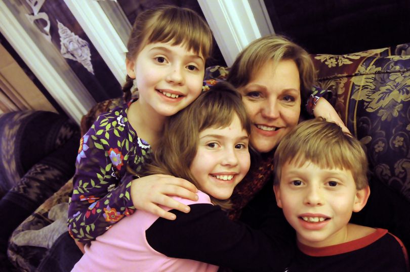 Linda Donnelly, second from right, poses with her triplets, from left, Dana, Lauren and Adam, at her Spokane home. The triplets, who are about to turn 10, are the result of in vitro fertilization treatments by Dr. Edwin Robins, who had just started practicing in Spokane a decade ago. (Jesse Tinsley)