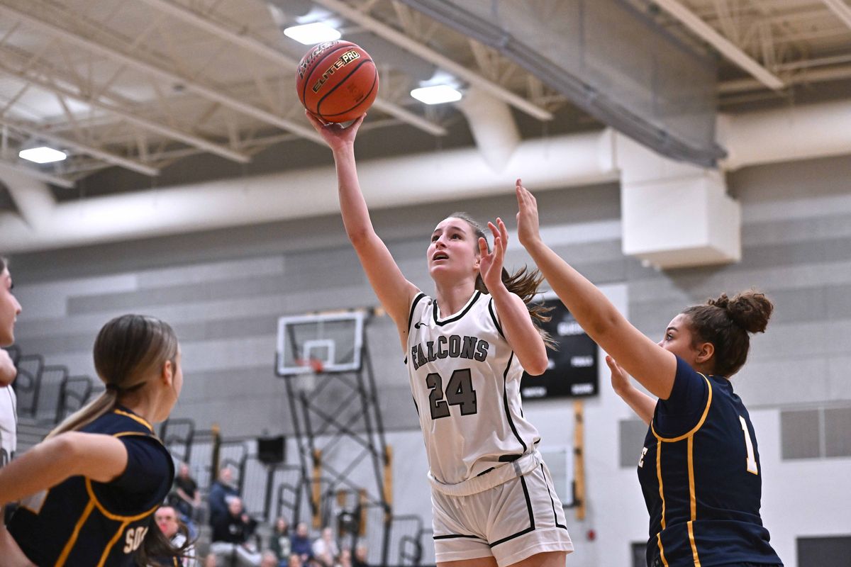 Ridgeline Falcons Noelia Axton (24) makes a basket against Southridge Suns Heidi Leonard (1) in the first half of a District 6 3A semifinal game on Tuesday, Feb. 17, 2026, at Falcon Gym in Liberty Lake, WA.  (James Snook)