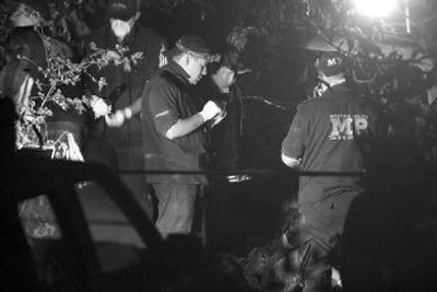 
Police examine the place where they found a body of a Salvadoran official in  Guatemala on Feb. 20. Central America is becoming a favored route for drug traffickers, officials say. 
 (Associated Press / The Spokesman-Review)