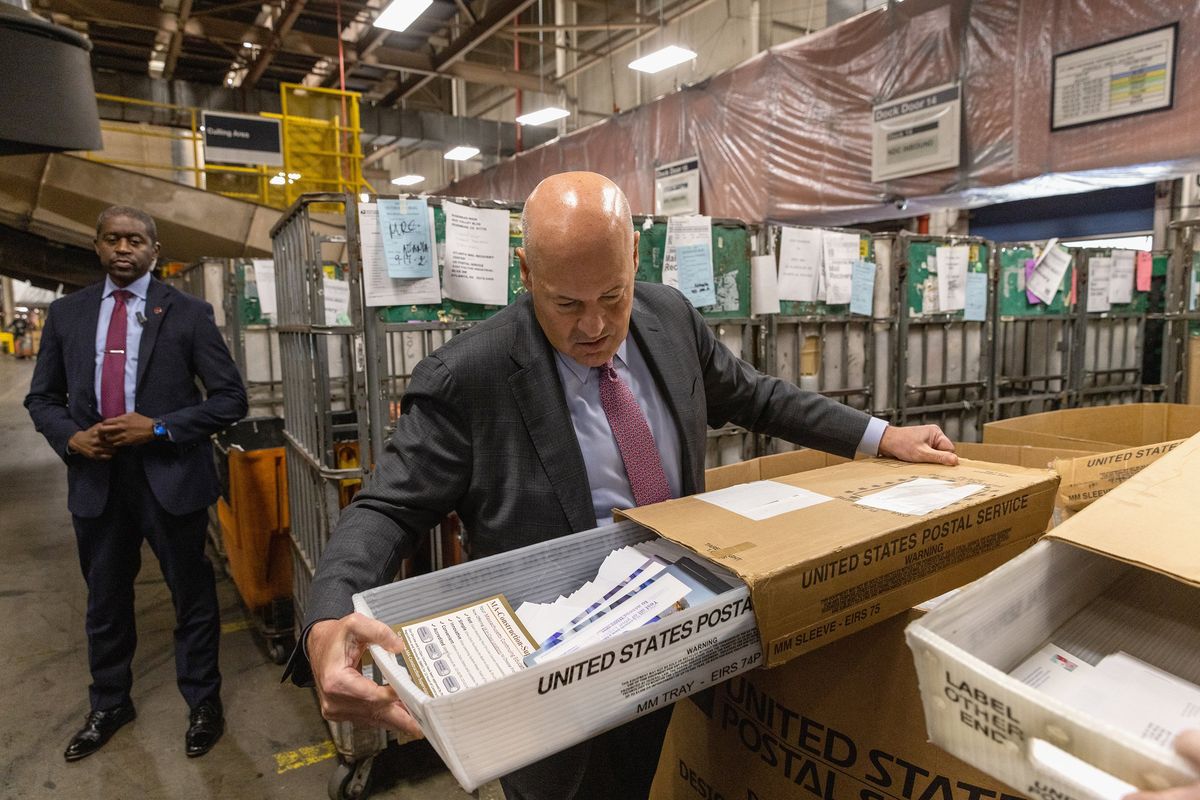 U.S. Postmaster General Louis DeJoy checks a carrier tray at a facility near Atlanta. MUST CREDIT: Photo for The Washington Post by Dustin Chambers  (Dustin Chambers/For The Washington Post)