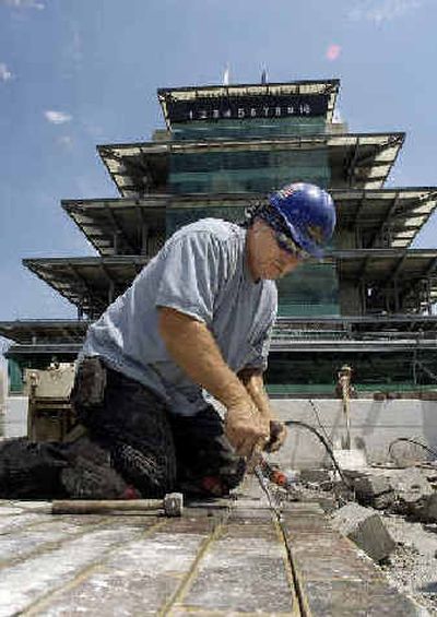
Doug Green removes the bricks that mark the start/finish line at the Indianapolis Motor Speedway.  
 (Associated Press / The Spokesman-Review)