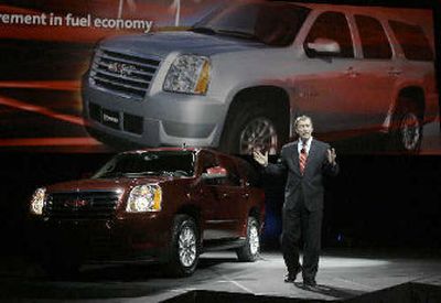 
General Motors Corp., North America president Troy Clarke, shows the new GM Hybrid SUV during the opening of the Los Angeles auto show Wednesday. 
 (Associated Press / The Spokesman-Review)