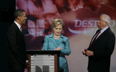 
Sen. Hillary Clinton, D-NY, checks her watch as Sen. Barack Obama, D-Ill, left, and former Alaska senator Mike Gravel speak during a break in Sunday's debate.Associated Press
 (Associated Press / The Spokesman-Review)