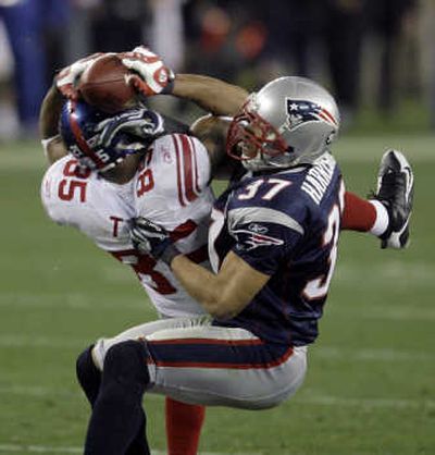 
David Tyree, left, will likely be remembered for this 32-yard reception in the clutches of Pats safety Rodney Harrison.Associated Press
 (Associated Press / The Spokesman-Review)