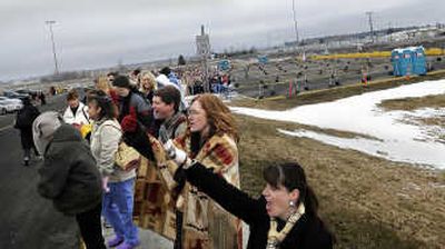 
Amy Kerns, front,  and Raina Strand, wrapped in a blanket,  of Coeur d'Alene, stand in line outside the Northern Quest Casino in Airway Heights  with other hopefuls on Tuesday. 
 (Christopher Anderson / The Spokesman-Review)