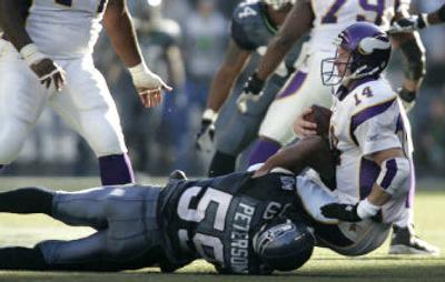 
Seattle's Julian Peterson brings down Minnesota's Brad Johnson for one of his team-high eight sacks this season.
 (Associated Press / The Spokesman-Review)