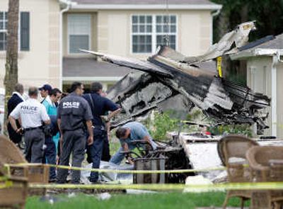 
Officials cover the body of  a victim at the scene of a plane crash  in Sanford, Fla., on Tuesday.Associated Press
 (Associated Press / The Spokesman-Review)