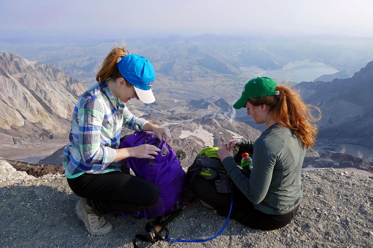 Climbers picnic on the rim of Mount St. Helens, the lava dome steaming in the crater below. (John  Nelson / The Spokesman-Review)