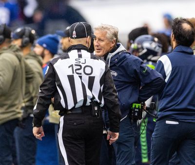 Seattle Seahawks coach Pete Carroll smiles at the side judge right after being flagged for illegal participation in the fourth quarter on Sunday, Oct. 30, 2022, at Lumen Field in Seattle.  (Dean Rutz/SEATTLE TIMES)