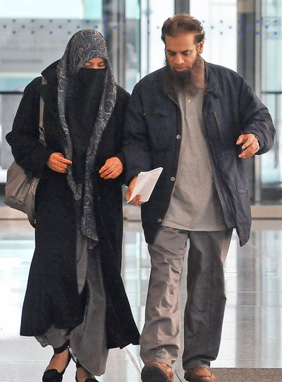 The parents of Mohammed Hamzah Khan, a 19-year-old from Bolingbrook, Ill., leave federal court Monday in Chicago. (Associated Press)