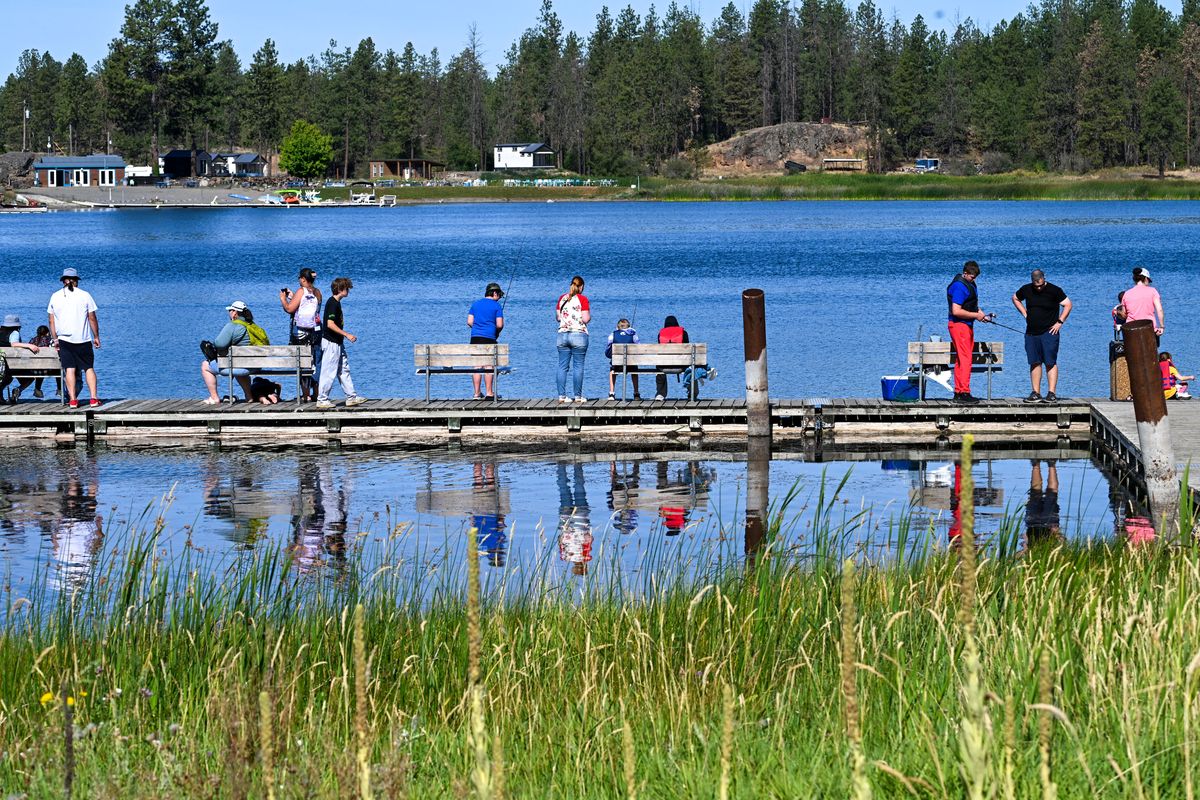 Participants line the dock during The Isaac Foundation Fish Pockets youth fishing event, Saturday Aug. 9, 2025 at Clear Lake. The gathering honored Brayden Bahme who tragically lost his life during a P.E accident at Cheney High School in April 2023. (DAN PELLE/FOR THE SPOKESMAN-REVIEW)