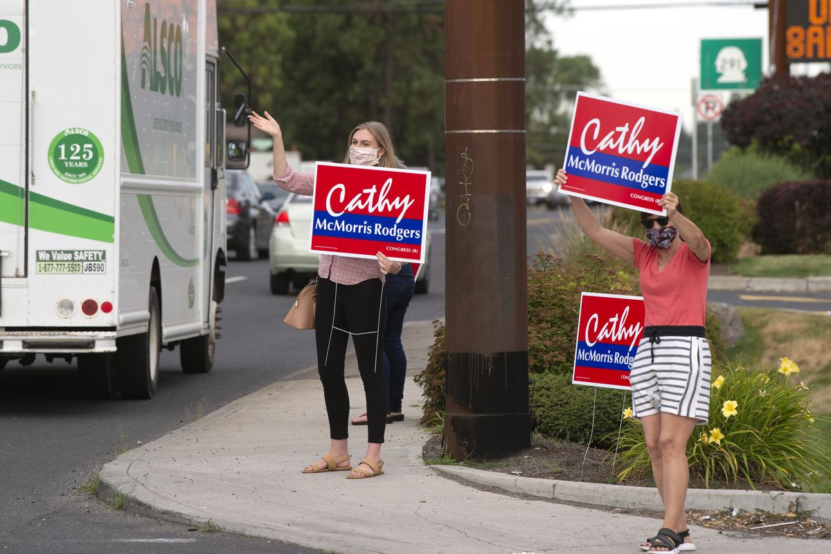 Emily Strode, left, and Dee Massey wave signs for Cathy McMorris Rodgers at the corner of Francis Avenue and Monroe Street, Thursday, July 23, 2020. Strode is McMorris Rodgers’ campaign manager.  (Jesse Tinsley/The Spokesman-Review)