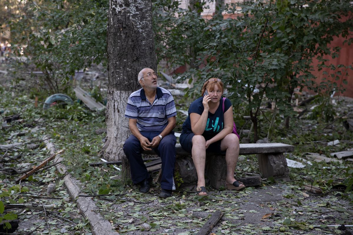Residents sit outside an apartment building that was damaged overnight by a Russian strike in Kramatorsk, Ukraine on Wednesday, Aug. 31, 2022. Ukraine said its forces conducted strikes in the Kherson region in the country