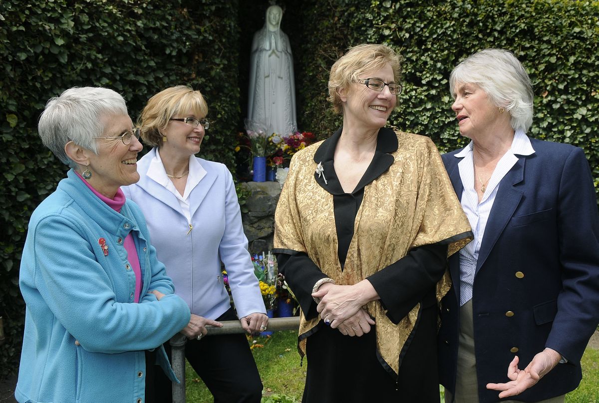 Mary Rathert, Mary Collins Murphy, Mary Ann Murphy and Mary Ann Heskett gather at the Mary statue on the Gonzaga University campus.  (Photos by Dan Pelle / The Spokesman-Review)