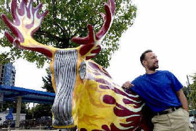 
Coeur d'Alene area artist David Clemons stands with his popular hot rod-themed moose that he painted as part of the No Moose Left Behind art project of the EXCEL Foundation. 
 (Jesse Tinsley / The Spokesman-Review)