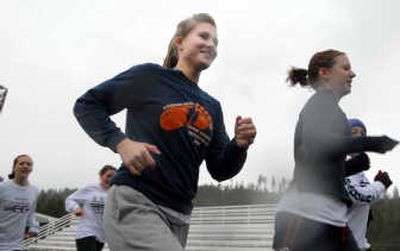 
Melody Braden trains in a steady rain on the track at Bonners Ferry High, continuing the family's cross country tradition. 
 (Jesse Tinsley / The Spokesman-Review)