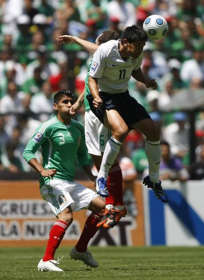 U.S. forward Brian Ching heads the ball against Mexico.  (Associated Press / The Spokesman-Review)