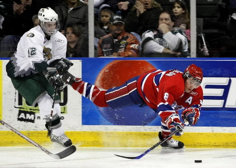 In this March 2008 file photo, Everett's Kyle Beach, left, sends Spokane's Jared Spurgeon sprawling after delivering a hit. The Spokane Chiefs have acquired forward Kyle Beach from the Lethbridge Hurricanes in exchange for defensemen Mike Reddington and Landon Oslanski. (File / The (Everett) Herald)