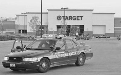 
Kansas City, Mo., police close down the parking lot at a shopping center in Kansas City on Sunday after a gunman opened fire in the lot and the Target store.
 (Associated Press / The Spokesman-Review)