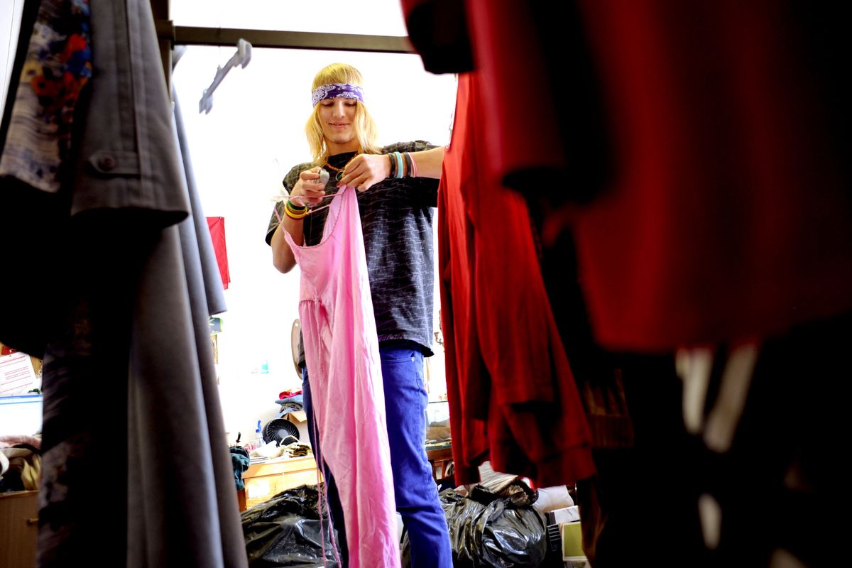 Jesse Myers, 18, hangs clothes at the Seconds Anyone? Thrift Store in Sandpoint on Sept. 23. (Kathy Plonka)