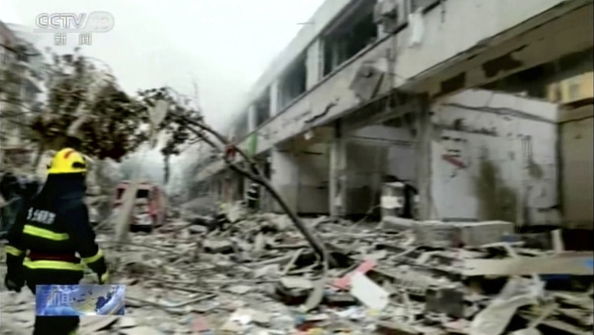 In this image taken from a video footage run by China’s CCTV, a firefighter walks near the aftermath of a gas explosion in Shiyan city in central China’s Hubei Province on Sunday, June 13, 2021. At least a dozen people were killed and more seriously injured Sunday after a gas line explosion tore through the residential neighborhood in central China.  (TEL)