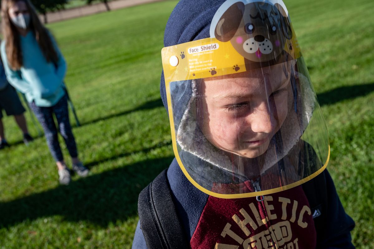 Arcadia Elementary School fourth grader Zayden Holt, 9, wears a face shield as he lines up outside the building on the first day of school, Tuesday, Sept. 8, 2020, in Deer Park, Wash.  (Colin Mulvany/THE SPOKESMAN-REVIEW)