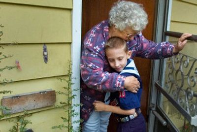 
Billie Gatlin hugs her hero, Caden Rogers, at the front door of the home where he found her unconscious Oct. 2 while selling popcorn door-to-door in a neighborhood near his Spokane neighborhood.  He visited her on Tuesday to tell her about the Red Cross naming him a Hometown Hero. 
 (Christopher Anderson/ / The Spokesman-Review)