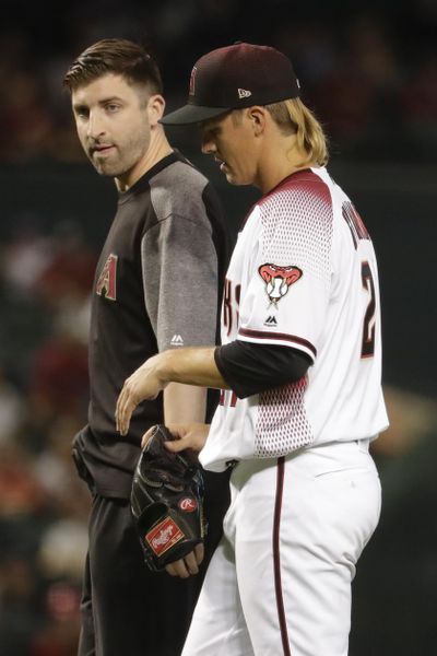 Arizona Diamondbacks starting pitcher Zack Greinke leaves the field with a trainer during the eighth inning of a baseball game against the Pittsburgh Pirates in Phoenix, Wednesday, May 15, 2019. (Matt York / Associated Press)