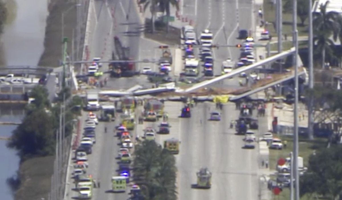 In this frame from video, emergency personnel work at the scene of a collapsed bridge in the Miami area, Thursday, March 15, 2018. (Associated Press)
