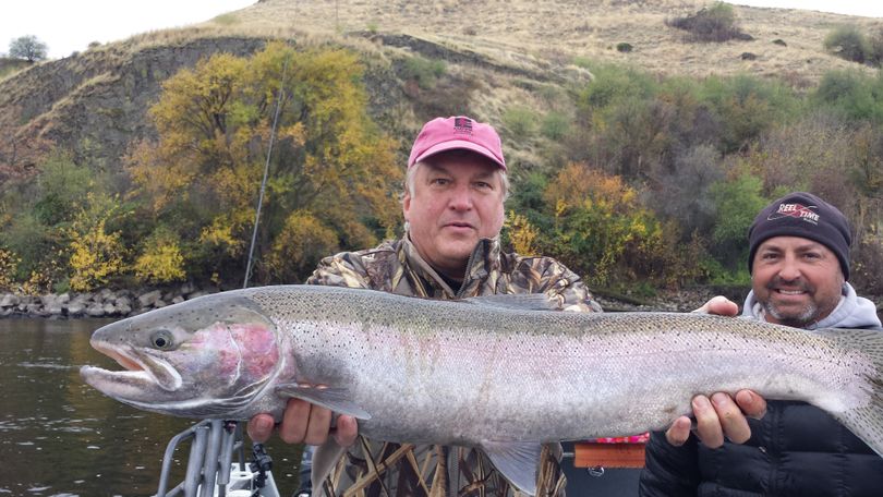 An angler holds a fine Clearwater steelhead caught with the help of Clarkston-based fishing guide Toby Wyatt, right. (Courtesy)