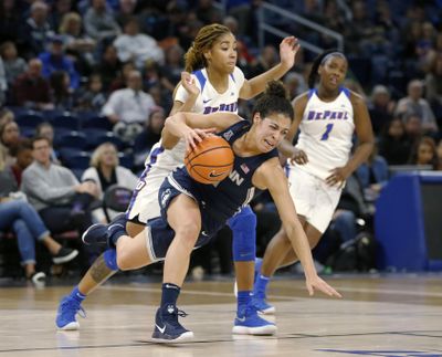 Connecticut guard Kia Nurse, front, is tripped by DePaul forward Mart’e Grays during the first half of an NCAA college basketball game Friday, Dec. 8, 2017, in Chicago. (Charles Rex Arbogast / Associated Press)