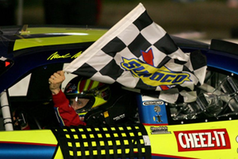 Mark Martin does a victory lap with the checkered flag after winning the Subway Fresh Fit 500 at Phoenix International Raceway. (Photo Credit: Todd Warshaw/Getty Images)  (Todd Warshaw / The Spokesman-Review)